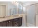 Bathroom featuring a double vanity with granite countertop and a glass-enclosed shower at 321 Falls Dr, Kissimmee, FL 34747