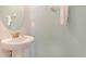 Simple and clean powder room with a pedestal sink and light blue walls at 321 Falls Dr, Kissimmee, FL 34747