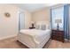 Bedroom featuring a comfortable bed, neutral carpet, and matching lamps and nightstands at 321 Falls Dr, Kissimmee, FL 34747