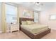 Inviting bedroom with tufted headboard, side tables, lamps, and green comforter at 321 Falls Dr, Kissimmee, FL 34747