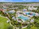 Aerial view of a community pool featuring a waterslide, splashpad, and plenty of seating at 321 Falls Dr, Kissimmee, FL 34747