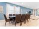 Spacious dining room with table for eight, stylish chairs, and windows with natural light at 321 Falls Dr, Kissimmee, FL 34747