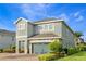 Two-story house with well-manicured landscaping and a stone-accented two-car garage at 321 Falls Dr, Kissimmee, FL 34747