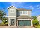 Two-story home with a stone-accented facade, well-manicured landscaping, and a two-car garage for curb appeal at 321 Falls Dr, Kissimmee, FL 34747