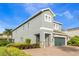 Charming house with a stone-accented two-car garage, side yard, and well-maintained landscaping at 321 Falls Dr, Kissimmee, FL 34747