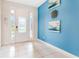 Bright foyer with tile flooring, blue accent wall, and natural light from the glass paneled front door at 321 Falls Dr, Kissimmee, FL 34747