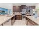 Well-equipped kitchen with stainless steel appliances, dark cabinets, and granite countertops at 321 Falls Dr, Kissimmee, FL 34747