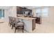 Bright kitchen featuring an island with seating, stainless appliances, and white tile flooring at 321 Falls Dr, Kissimmee, FL 34747
