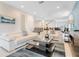 Bright and airy living room with sofas, modern decor, and views into dining and entry areas at 321 Falls Dr, Kissimmee, FL 34747