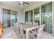 Covered patio with large table and seating for eight, perfect for outdoor dining at 321 Falls Dr, Kissimmee, FL 34747