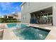 Back patio featuring an outdoor dining area with a pool and spa at 321 Falls Dr, Kissimmee, FL 34747