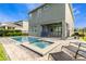 Backyard view of pool, spa, patio, and grill of well-manicured and fenced yard at 321 Falls Dr, Kissimmee, FL 34747
