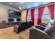Home theater room with tiered seating and a large television for the ultimate viewing experience at 321 Falls Dr, Kissimmee, FL 34747