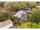Aerial view of the residence displaying the backyard pool and screened-in enclosure amidst lush greenery in a serene setting at 345 W Hornbeam Dr, Longwood, FL 32779