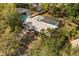 A high angle shows the home featuring a screened pool with backyard and roof in a serene tree filled neighborhood at 345 W Hornbeam Dr, Longwood, FL 32779