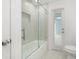 Bathroom features a shower over tub, glass enclosure, and tiled walls at 345 W Hornbeam Dr, Longwood, FL 32779