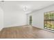 Bright bedroom with hardwood floors, two windows offering natural light, and neutral walls at 345 W Hornbeam Dr, Longwood, FL 32779