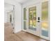 Bright entryway showcasing a stylish front door with decorative glass and sidelights, plus wood-look flooring at 345 W Hornbeam Dr, Longwood, FL 32779