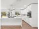 Modern kitchen features white cabinets, quartz countertops, stainless steel appliances, and peninsula seating at 345 W Hornbeam Dr, Longwood, FL 32779