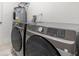 Modern laundry room with front-load washer and dryer at 345 W Hornbeam Dr, Longwood, FL 32779