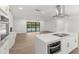 Open living area with kitchen and a large sliding glass door offering views of the backyard pool at 345 W Hornbeam Dr, Longwood, FL 32779