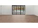 Bright living room featuring hardwood floors and glass sliding doors overlooking the outdoor pool at 345 W Hornbeam Dr, Longwood, FL 32779