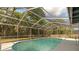 Inviting pool area with a screened enclosure, surrounded by greenery at 345 W Hornbeam Dr, Longwood, FL 32779