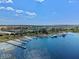 Community aerial shot features stunning lake views, numerous private docks, and beautiful landscaping with waterside homes at 3456 Shallow Cove Ln, Clermont, FL 34711