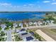 Stunning aerial view of a lakeside property with a well-manicured lawn and beautiful landscaping at 3456 Shallow Cove Ln, Clermont, FL 34711