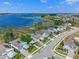 Waterfront neighborhood aerial highlights well-maintained homes, a serene lake, and private wooden docks for boating and recreation at 3456 Shallow Cove Ln, Clermont, FL 34711
