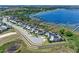 Stunning aerial view of waterfront homes with private docks on a serene lake, showcasing the community's beautiful setting at 3456 Shallow Cove Ln, Clermont, FL 34711