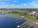 Expansive aerial showcases neighborhood docks; community boasts lake access, scenic walkways, and serene water views at 3456 Shallow Cove Ln, Clermont, FL 34711