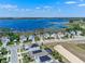 Lakeside neighborhood aerial featuring modern homes with solar panels, a tranquil lake, and convenient private docks at 3456 Shallow Cove Ln, Clermont, FL 34711