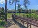 Beautiful backyard and wooden bridge access to the community amenities, offering privacy and easy access to recreation at 3456 Shallow Cove Ln, Clermont, FL 34711