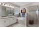 Well-appointed bathroom with double vanity, soaking tub, and a glass-enclosed shower creates a spa-like experience at 3456 Shallow Cove Ln, Clermont, FL 34711