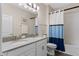 Neat bathroom featuring double sinks, granite countertop, and tub-shower combo for everyday convenience at 3456 Shallow Cove Ln, Clermont, FL 34711