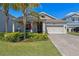 Charming single-Gathering home with well-manicured lawn, lovely landscaping and a welcoming covered porch at 3456 Shallow Cove Ln, Clermont, FL 34711