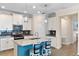 Stylish kitchen featuring an island with seating, stainless steel appliances, and modern cabinetry at 3456 Shallow Cove Ln, Clermont, FL 34711