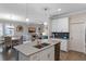 Modern open-concept kitchen with island, stainless steel appliances, and stylish pendant lighting at 3456 Shallow Cove Ln, Clermont, FL 34711