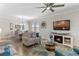 Inviting living room with coastal decor, a fireplace, and an open dining area creates a warm and welcoming space at 3456 Shallow Cove Ln, Clermont, FL 34711