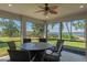 Relaxing screened-in lanai showcasing stunning lake views and a dining space for alfresco enjoyment at 3456 Shallow Cove Ln, Clermont, FL 34711