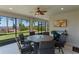 Inviting screened-in lanai featuring beautiful lake views and a dining area for outdoor relaxation and entertainment at 3456 Shallow Cove Ln, Clermont, FL 34711