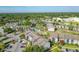 Aerial view of a residential community featuring lush landscaping, parking areas, and a pool at 3700 Idlebrook Cir # 114, Casselberry, FL 32707