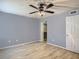 Bedroom with wood grain floors, a ceiling fan, window, closet and neutral walls at 3700 Idlebrook Cir # 114, Casselberry, FL 32707