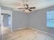Bedroom area with wood grain floors, a ceiling fan, window and a view to the hall at 3700 Idlebrook Cir # 114, Casselberry, FL 32707