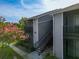 Two-story apartment building featuring stairs, private balconies, and beautiful flowering trees at 3700 Idlebrook Cir # 114, Casselberry, FL 32707