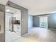 Open living room with a view to updated kitchen with stainless appliances and white cabinetry at 3700 Idlebrook Cir # 114, Casselberry, FL 32707