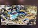 Aerial view of a sparkling pool, playground, and other amenities, all surrounded by lush greenery and well-maintained landscaping at 3700 Idlebrook Cir # 114, Casselberry, FL 32707