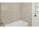 Tiled shower and tub featuring a window at 3994 Irma Shores Dr, Orlando, FL 32817