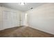 Comfortable bedroom featuring neutral walls, carpet flooring, and a closet with bi-fold doors at 3994 Irma Shores Dr, Orlando, FL 32817